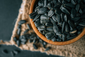 Sunflower seeds in wooden bowl on a rural background