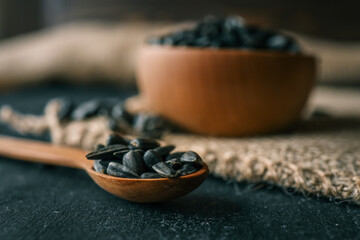 Sunflower seeds in wooden bowl on a rural background