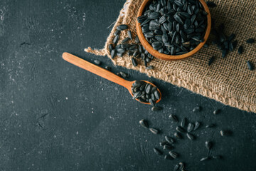 Sunflower seeds in wooden bowl on a rural background