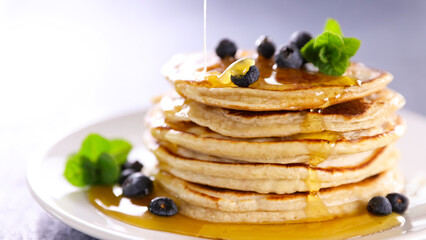 Homemade american pancakes with blueberries and honey