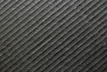 A sheet of black glossy corrugated cardboard texture as background
