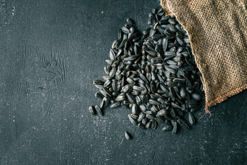 Sunflower seeds spill out of a bag