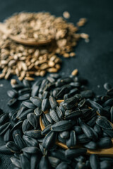 Assortment of sunflower grains, black background
