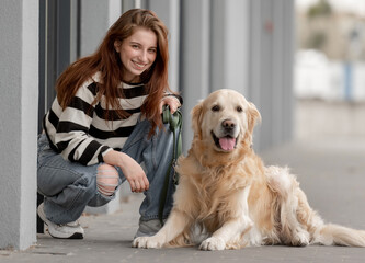 Teen Girl With Golden Retriever Near Store Plays In Spring