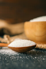 Sugar in a wooden bowl on burlap