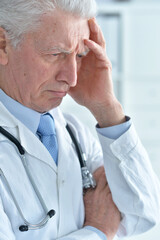 Portrait of confident senior male doctor in office