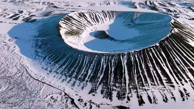 Aerial drone view of volcanic crater covered by snow and ice, winter landscapes of Northern Iceland