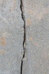 Fototapeta premium Deep crack in an old brick wall with damaged plaster