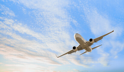 White passenger airplane flying in the sky amazing clouds in the background - Travel by air transport