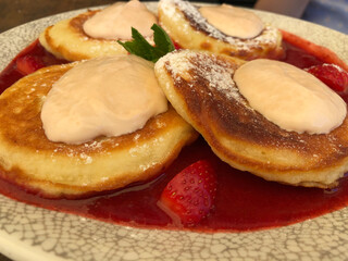 Small pancakes with strawberry syrup