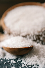 Pour salt into a wooden spoon, close-up