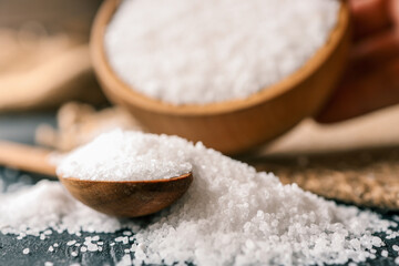 Pour salt into a wooden spoon, close-up