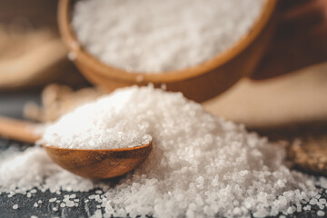 Pour salt into a wooden spoon, close-up