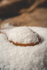 Wooden spoon with salt, close-up