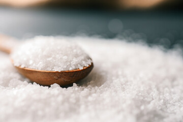 Wooden spoon with salt, close-up