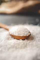 Wooden spoon with salt, close-up