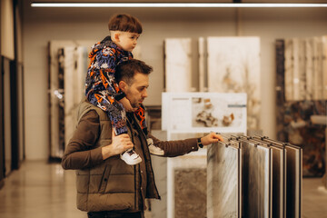 father and son choose tiles for the floor