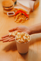 A woman holding a bowl of popcorn