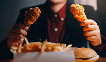 close up focus woman hand hold fried chicken for eat,girl with fast food concept