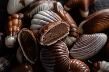 Chocolate candies in the shape of shells on a dark background