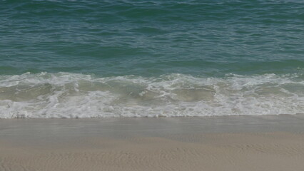 Serene Ocean Waves Gently Crashing on Sandy Shore
