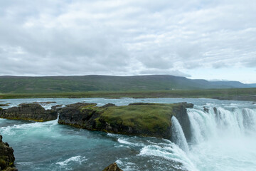 Iceland Akureyri landcape with waterfall on the river on a sunny day