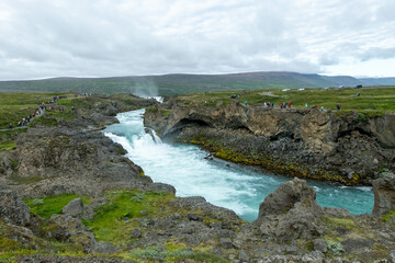 Icelandic landscape of the body of water, lakes and waterfall on a cloudy day from Akureyri