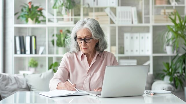 An elderly woman writing notes
