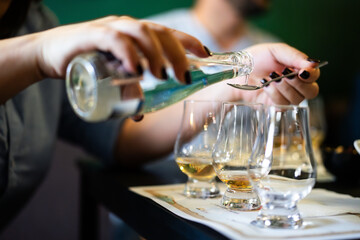 Person adding water in a whisky glass