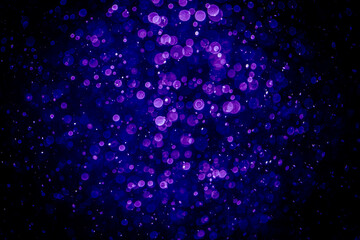 Blurred photo with purple violet and blue dots visible glittering, shining brightly look and feel luxurious