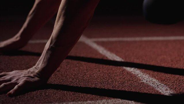 Closeup View Of Muscular Runner Hands On Floor Of Sprinter Lane, Man Standing In Low Start Position