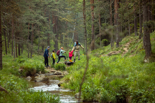 Multi-generational family hiking together in the forest