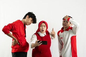 a group of young asian people are looking at cell phones, celebrating indonesian independence day 17 august, independence day concept, isolated on white background.