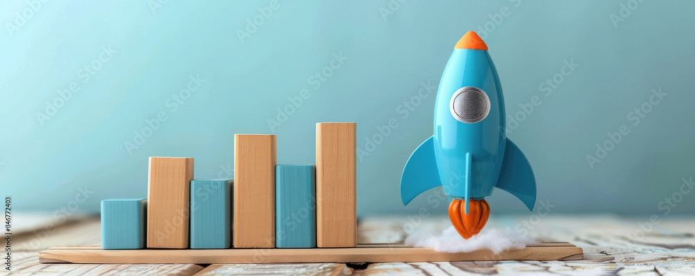 Poster a blue rocket is flying through the air with a wooden block tower in the background. the rocket is p