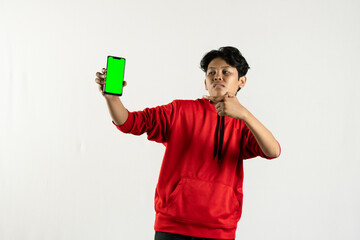 young asian man using his green screen cellphone to show something. independence day concept. isolated white background
