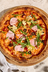 Gourmet Pizza with Mortadella, Artichokes, and Arugula in Summer Sunlight