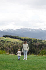 Mother and son walking in mountain valley