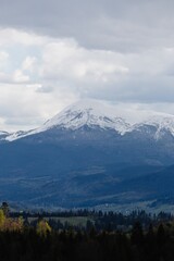 Snowy mountain range under cloudy sky