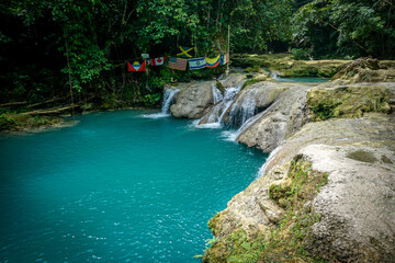 Blue Hole Waterfalls in Jamaica, pristine beautiful falls with vibrant blue and green colors.