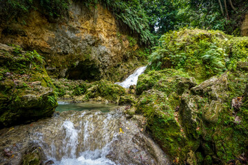 Blue Hole Waterfalls in Jamaica, pristine beautiful falls with vibrant blue and green colors.