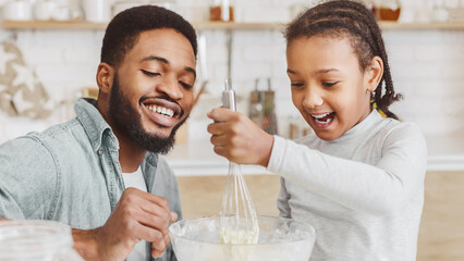 Cheerful Black Dad Teaching Lovely Daughter How To Make Dough, kitchen interior, panorama