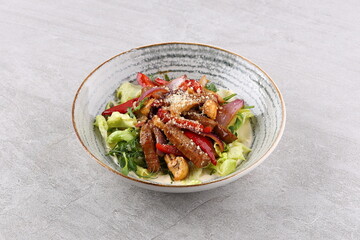 Beef steak salad with cherry tomatoes, cucumbers, red onions, romaine salad and lime mustard olive oil salad dressing