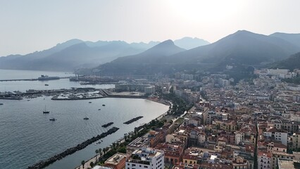 Fototapeta premium Salerno, in Campania, is famous for the stunning Amalfi Coast. It offers breathtaking views of the Tyrrhenian Sea, beautiful beaches, and a lively promenade, perfect for scenic walks