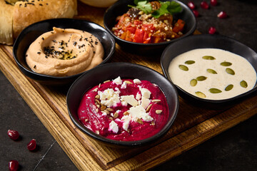 Assorted Meze with Pita and Flatbread Featuring Hummus, Ajapsandali, Beet Hummus, and Tonnato Sauce