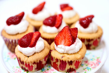 Homemade muffin with small pieces of strawberries, photographed in ambiental light.