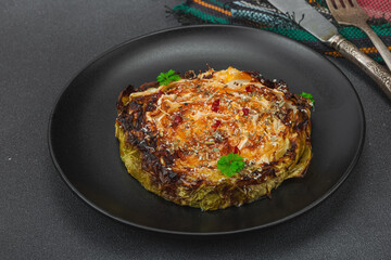 Homemade vegan cabbage steaks with herbs and spices. Healthy food ready to eat on a serving plate