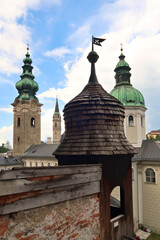 Inside the catacombs of Salzburg at the St., Saint Peter's Cemetery, Petersfriedhof, view from the Getrauden Chapel, Getraudenkapelle onto different bell, clock towers, Salzburg, Austria