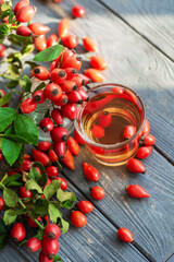 Dog rose with bunch branch Rosehips, types Rosa canina hips and herbal tea composition