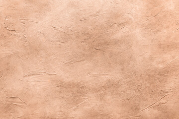 Peach fuzz textured surface, closeup. Trendy shade of 2024 year