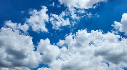 Obraz premium Blue sky with white clouds, bright colored cloudscape banner. Fluffy heaven pattern, aesthetic natural scene. Beautiful Cloudy background, nature environment wallpaper, panoramic view